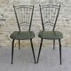 Black metal chairs with khaki faux leather seats, circa 1960.