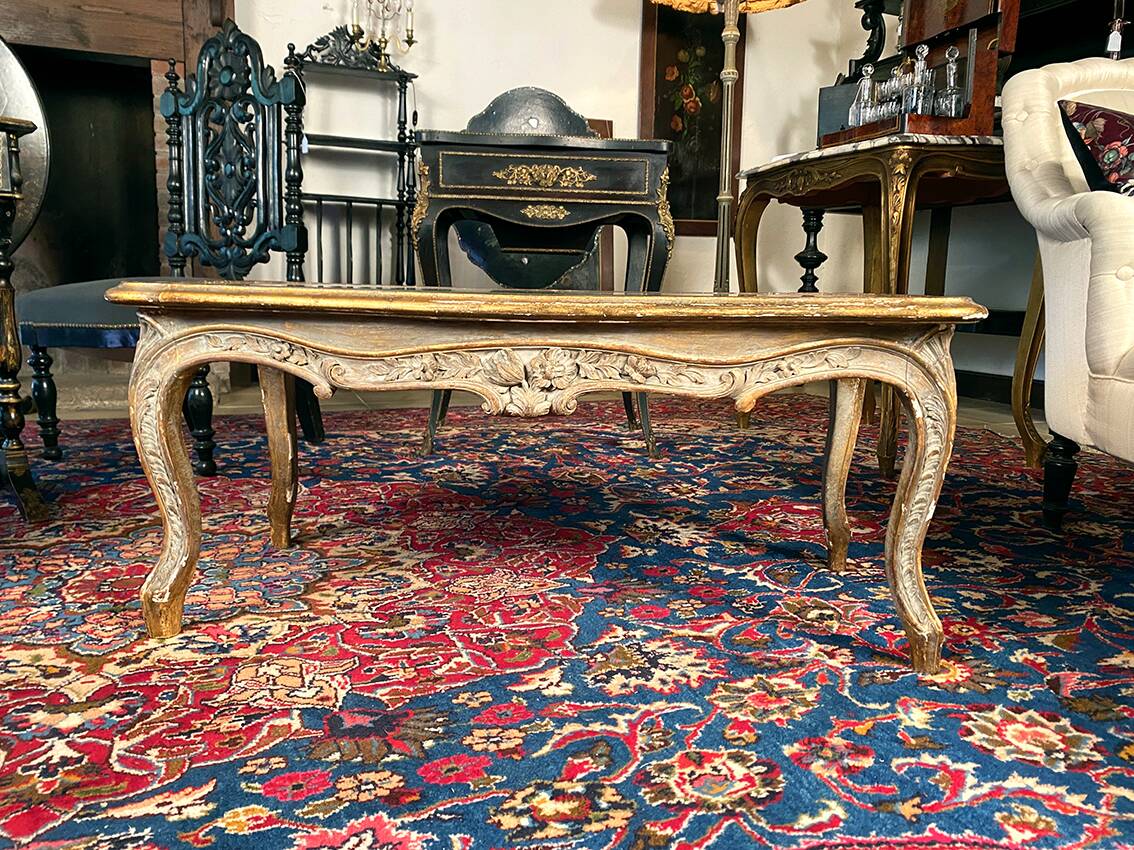 Louis XV style coffee table in carved wood with grey and gold highlights.