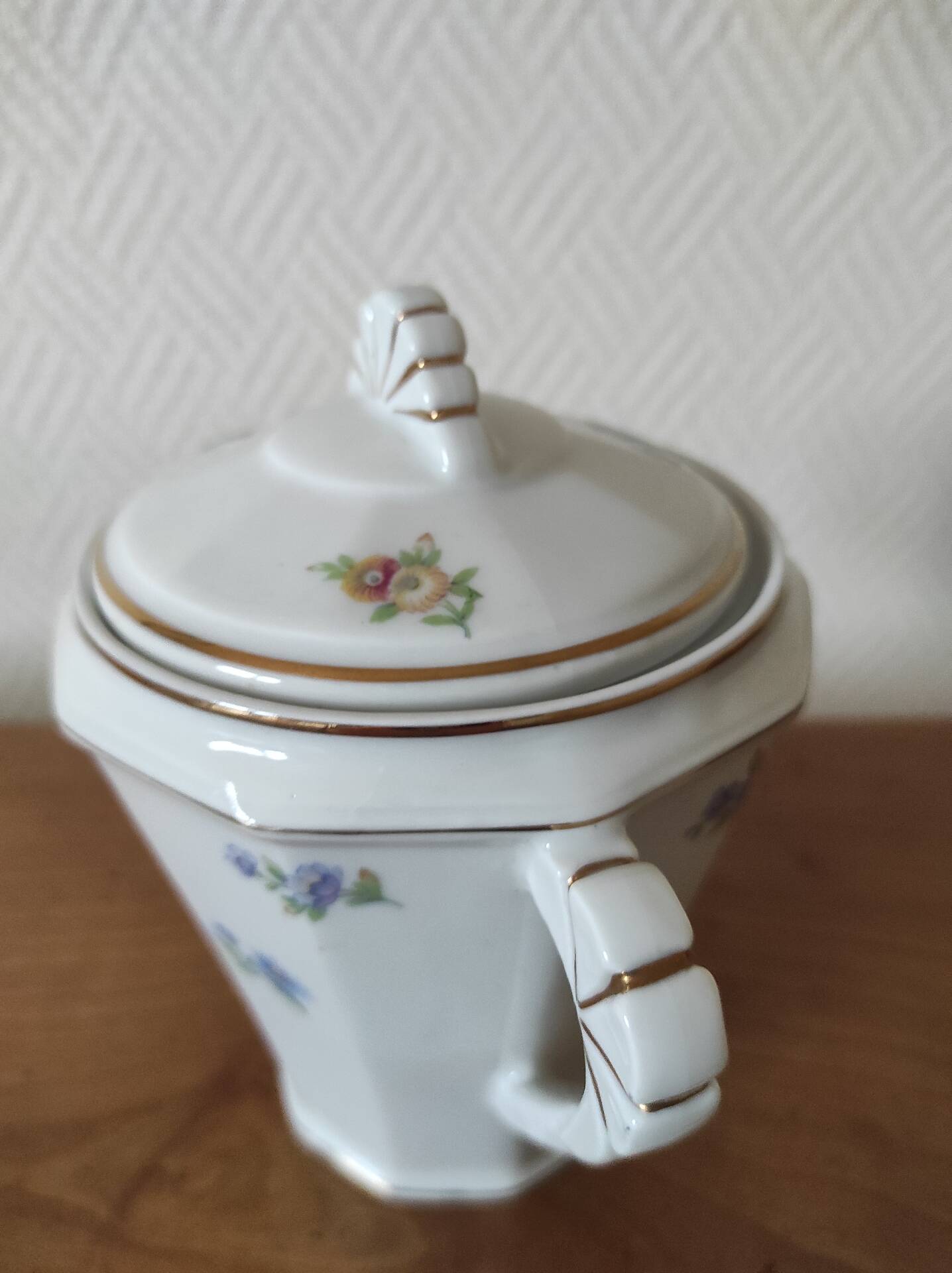Antique porcelain sugar bowl with a decagonal base.