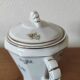 Antique porcelain sugar bowl with a decagonal base.