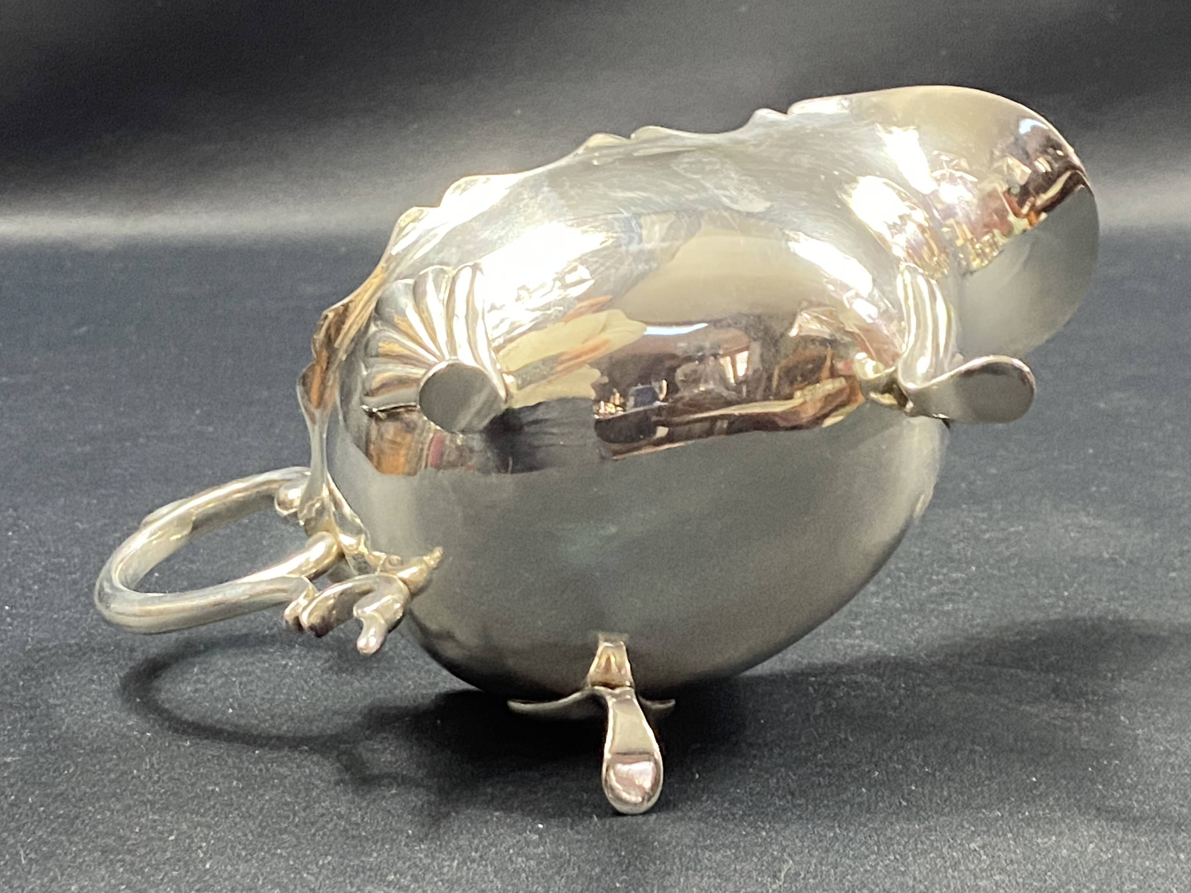 English George III style silver plated tripod sauce boat