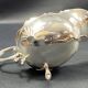 English George III style silver plated tripod sauce boat
