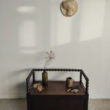 Natural wood chest forming a bench, ringed shoulders