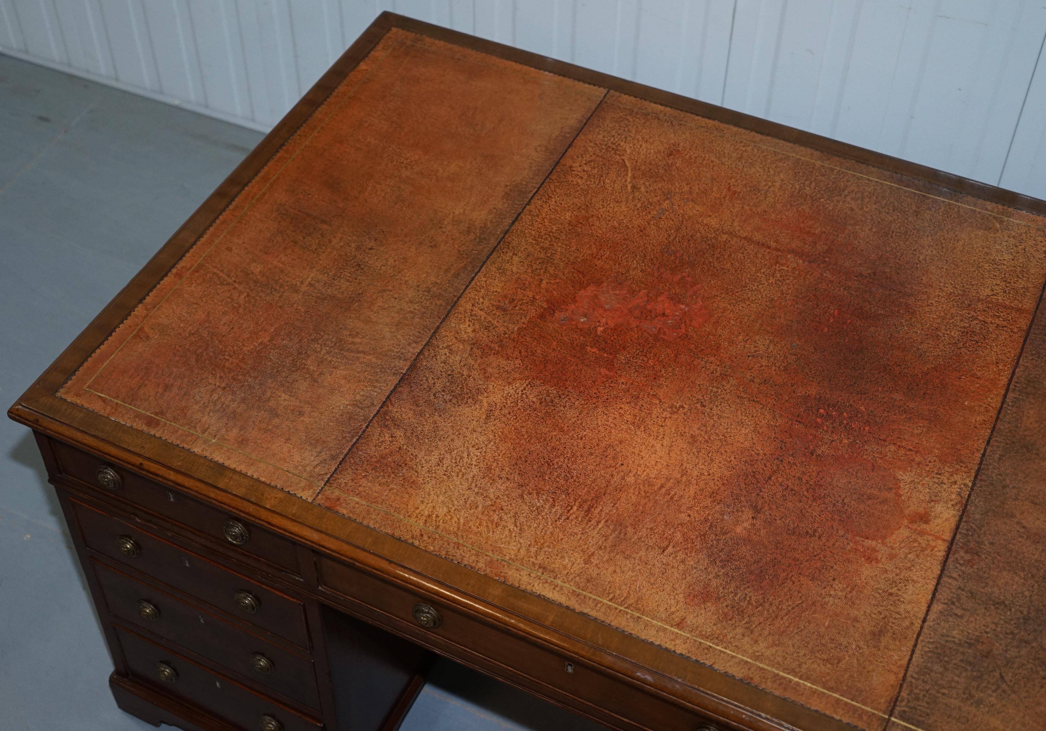 Double-sided partner's desk in walnut, George III, circa 1780, with lion head handles.
