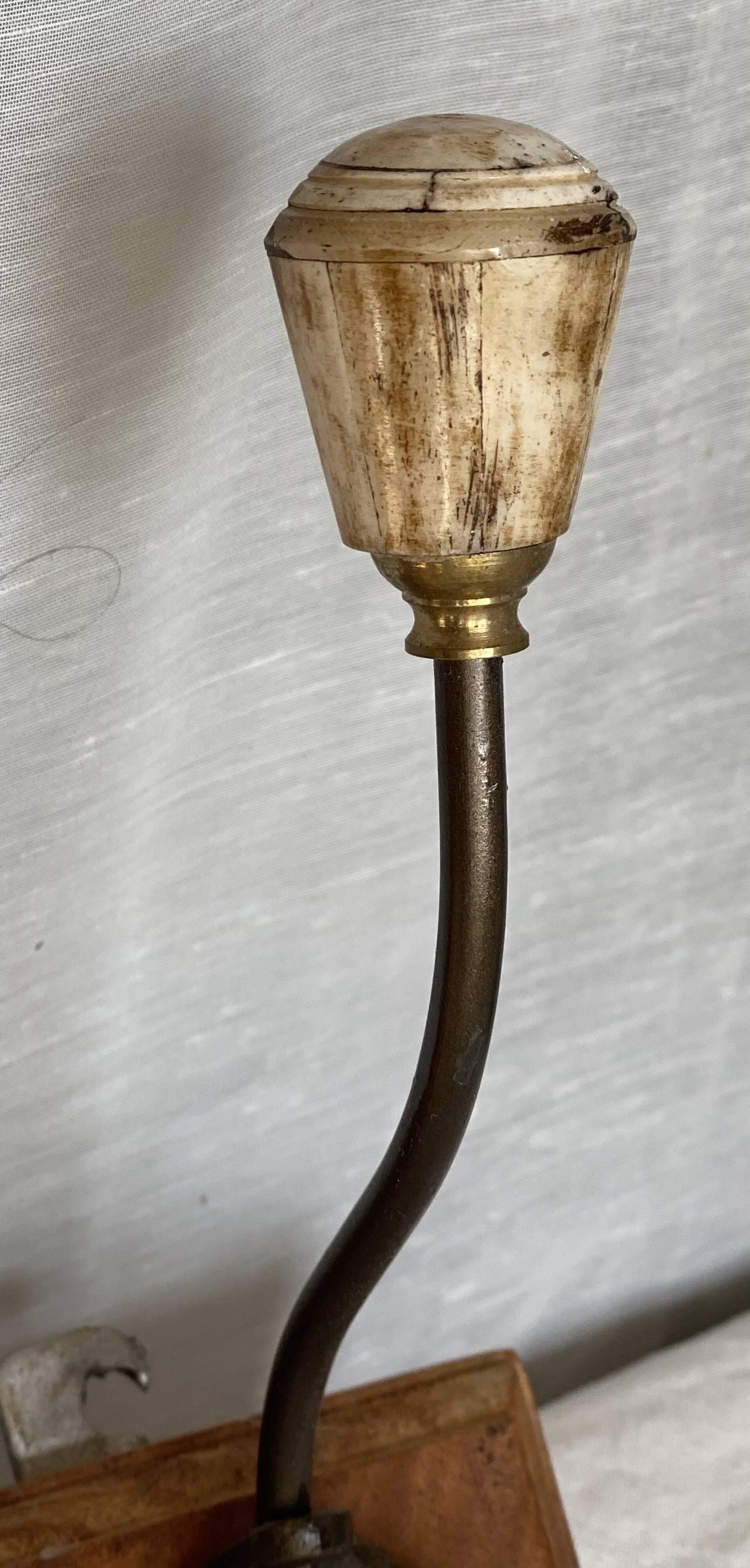 19th-century wall coat rack with 2 metal and horn hooks.