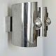 Pair of vintage wall lights, curved chrome metal, France, 1970.
