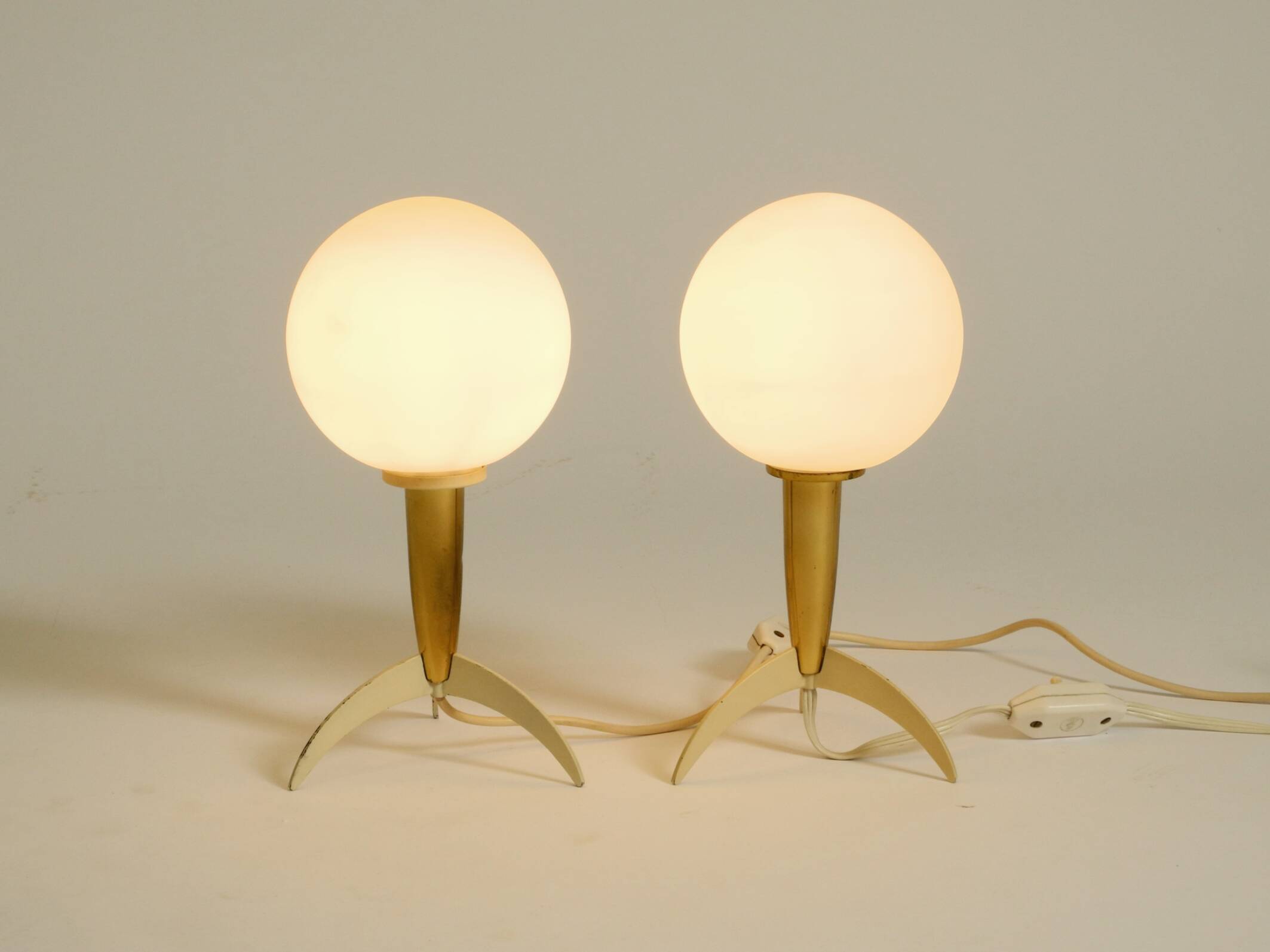 Two Mid-Century Modern rocket table lamps in brass and glass