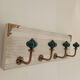 Wall-mounted coat rack in bleached wood and emerald green ceramic hooks –