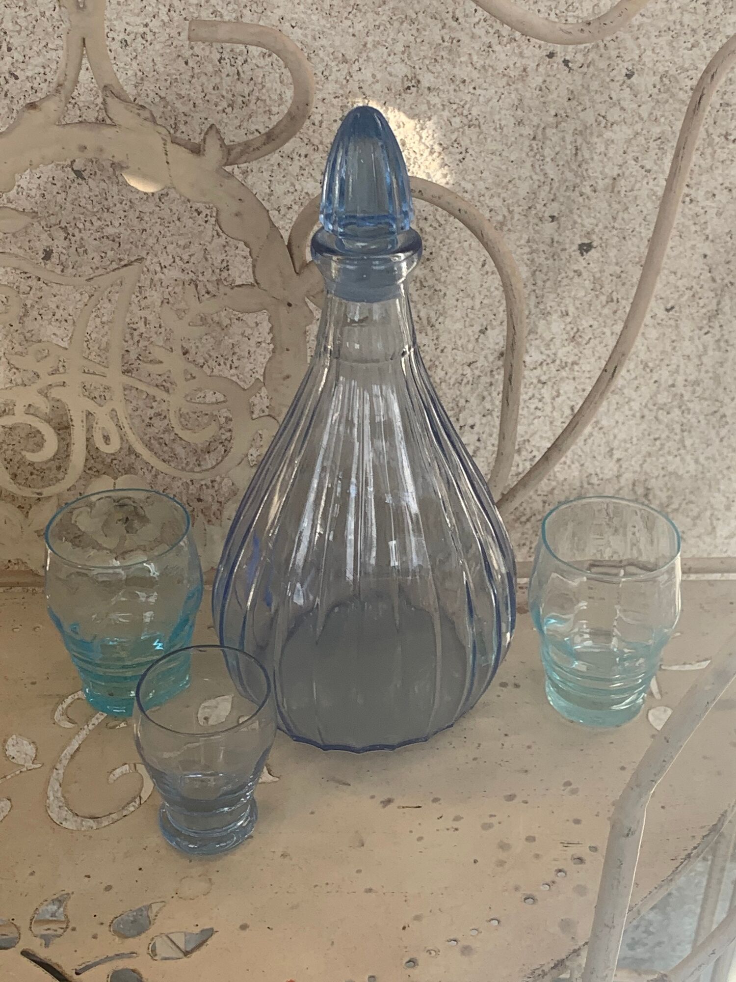 Liquor service consisting of a blue glass decanter and. 3 small antique glasses