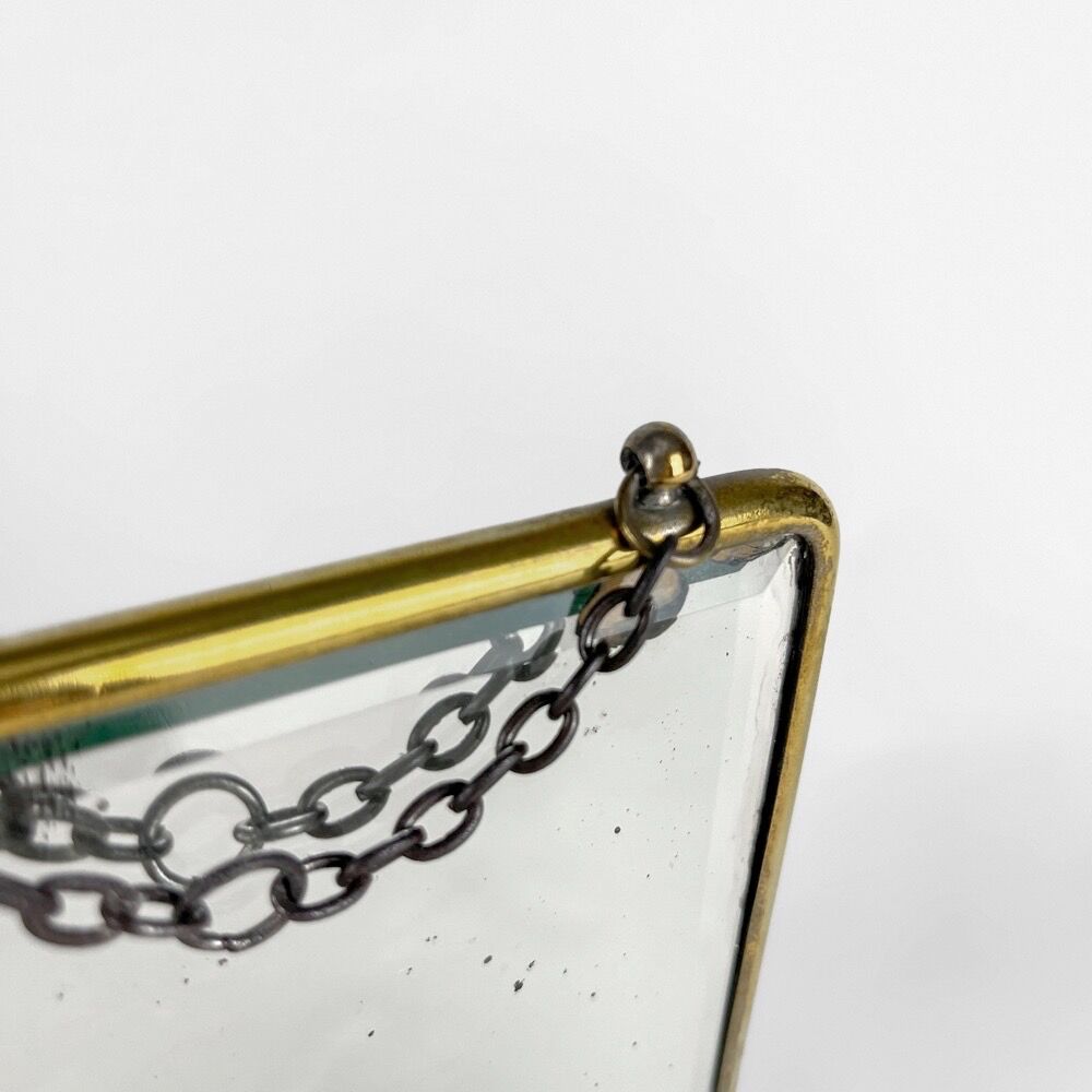 Old barber mirror in brass and beveled glass