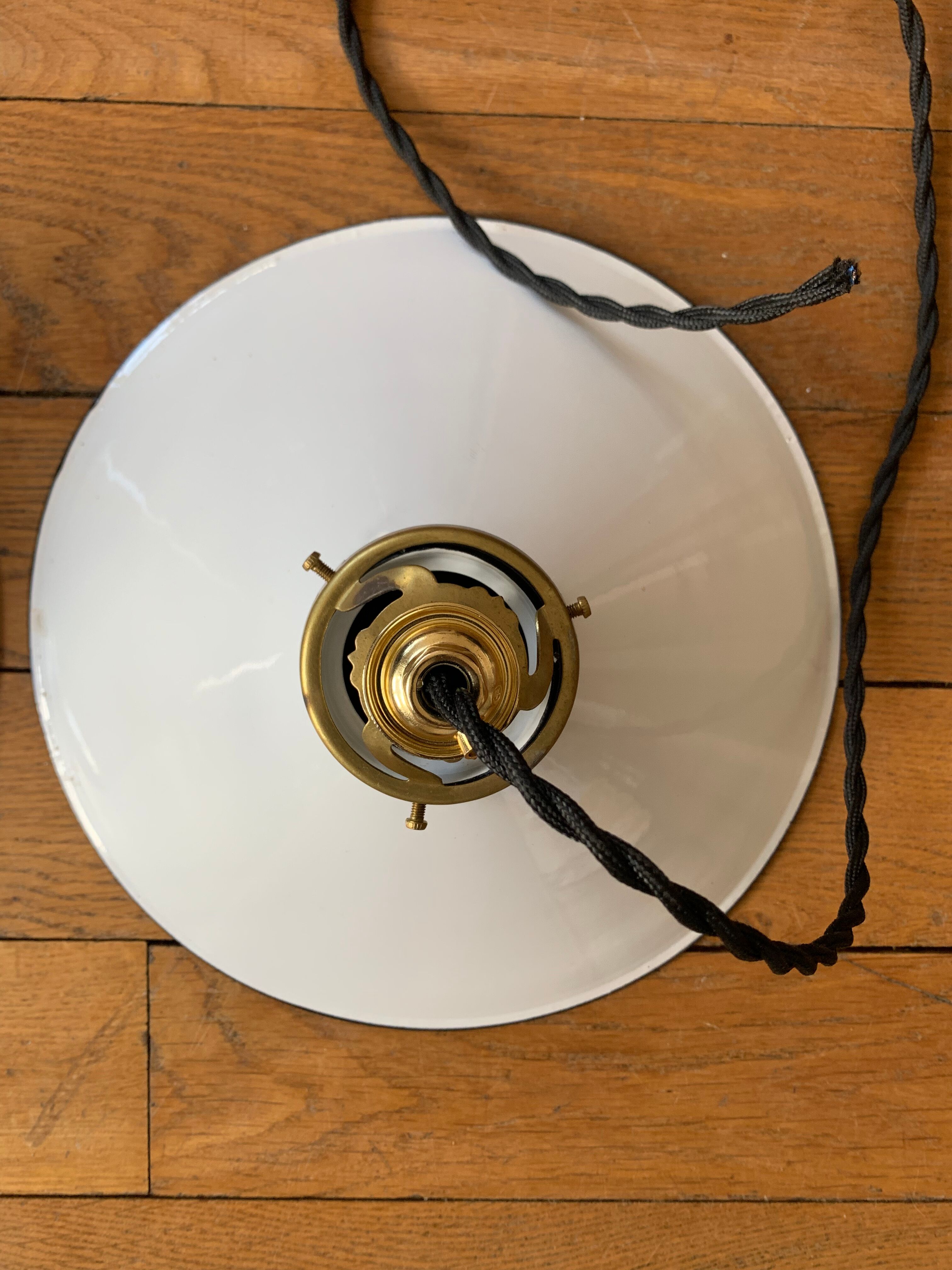 Old pair of white industrial metal suspensions with black border