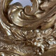 Large antique baroque mirror with angel decorations.