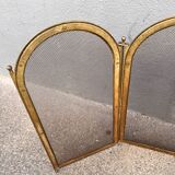 Antique brass fireplace screen from 1920, vintage spark guard.