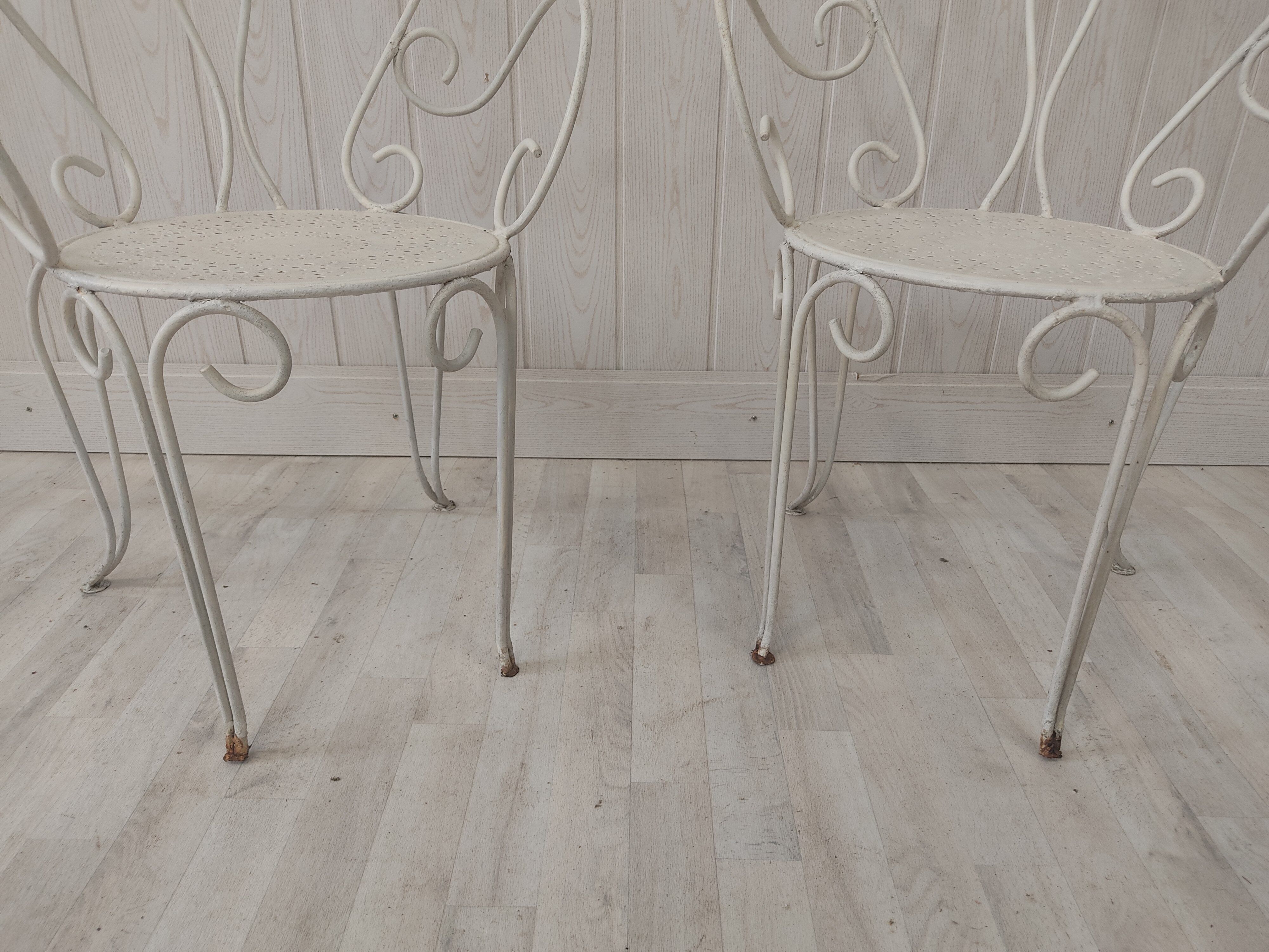 Pair of wrought iron garden chairs