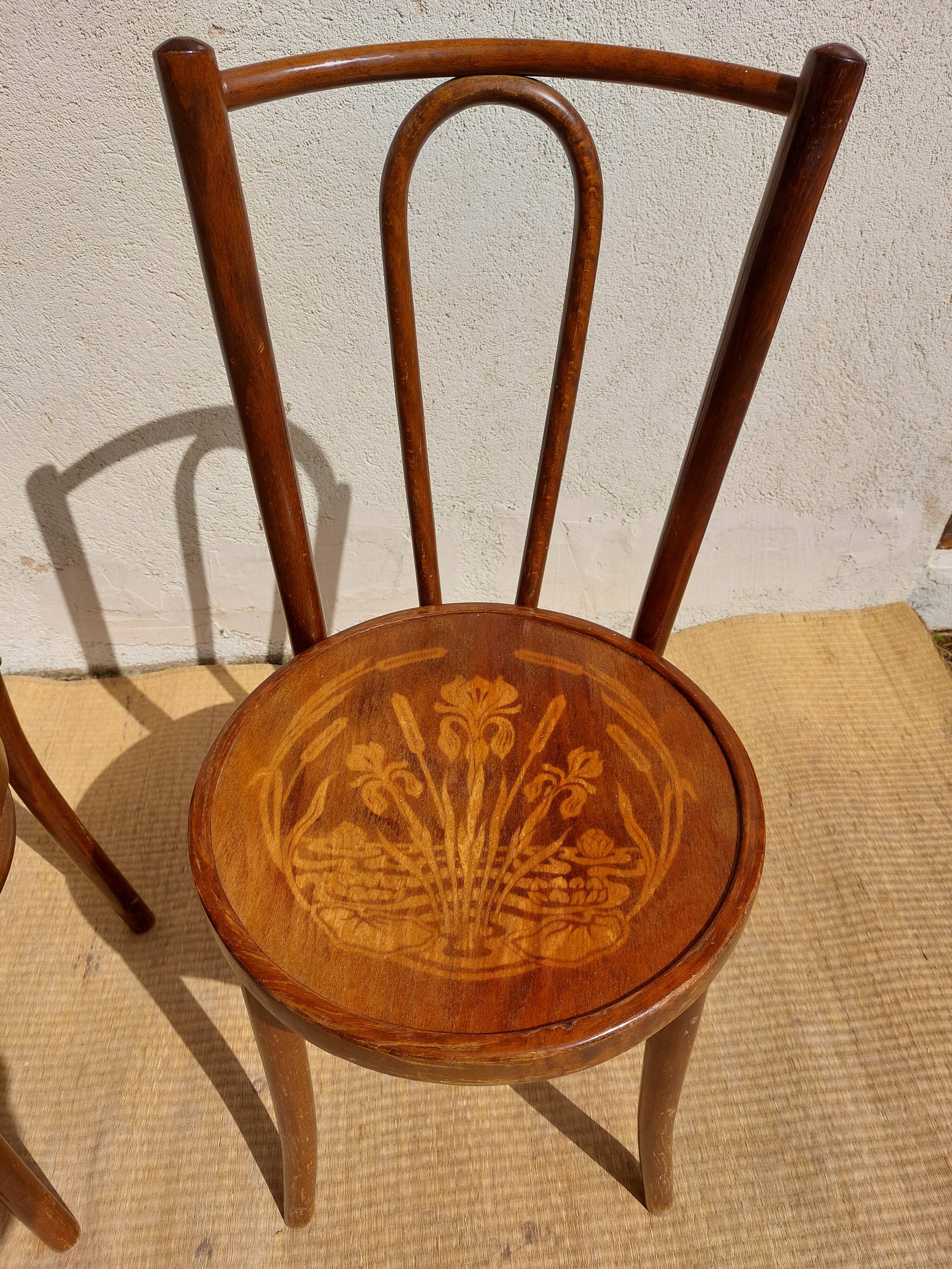 pair of bistro chairs, curved wood and pattern on the seat