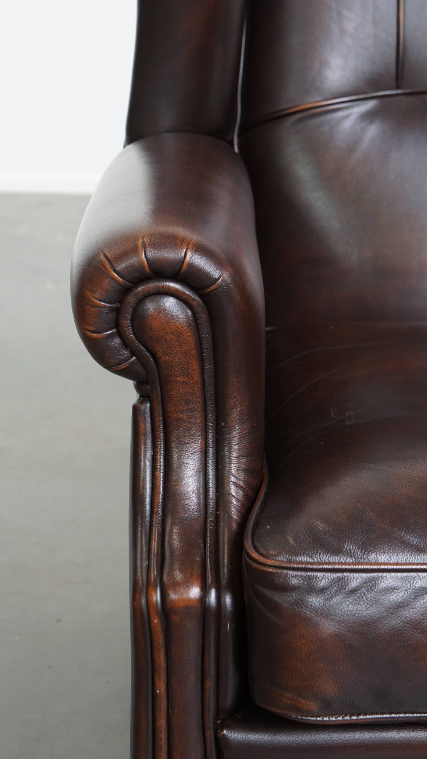 Comfortable wingback chair in English style made of cowhide leather