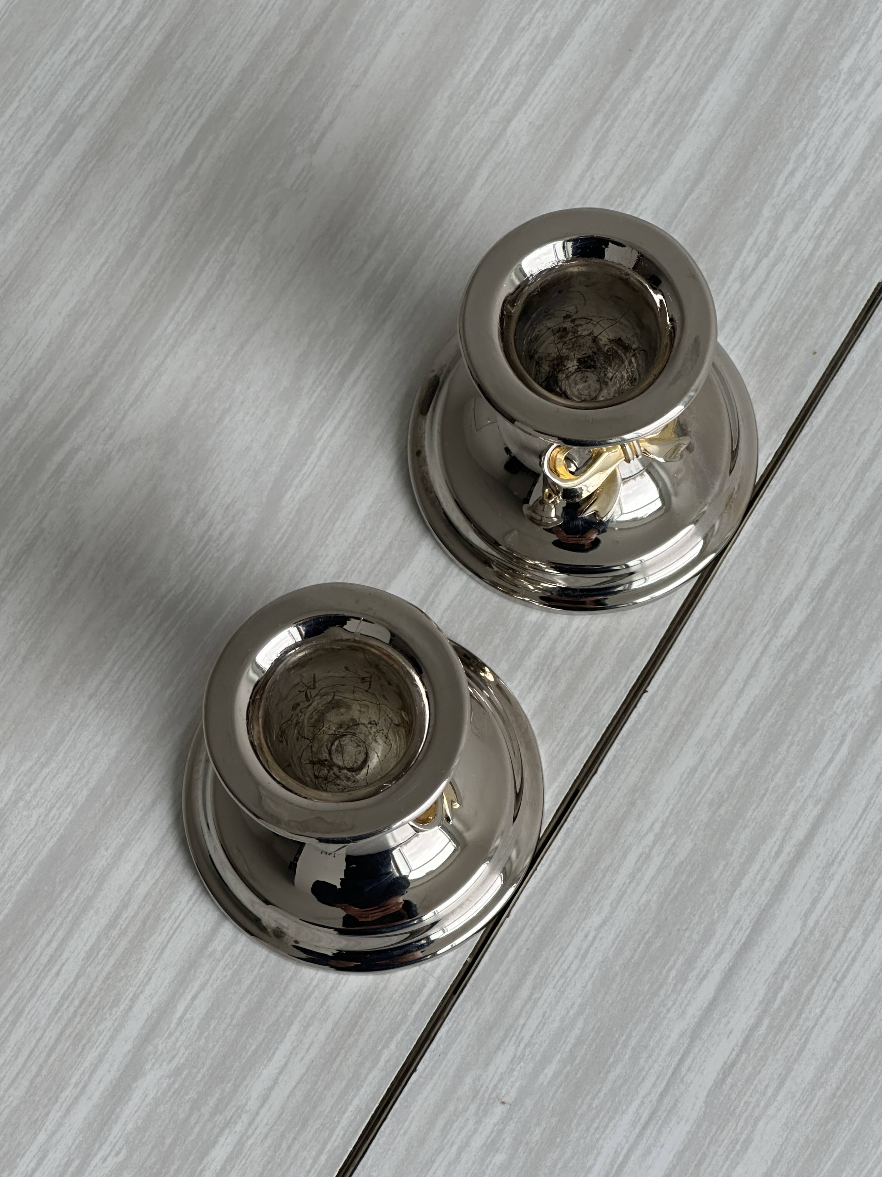 Pair of small antique metal candlesticks