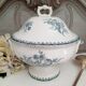 Old mismatched hollow plates in iron earth earthenware accompanied by a soup tureen