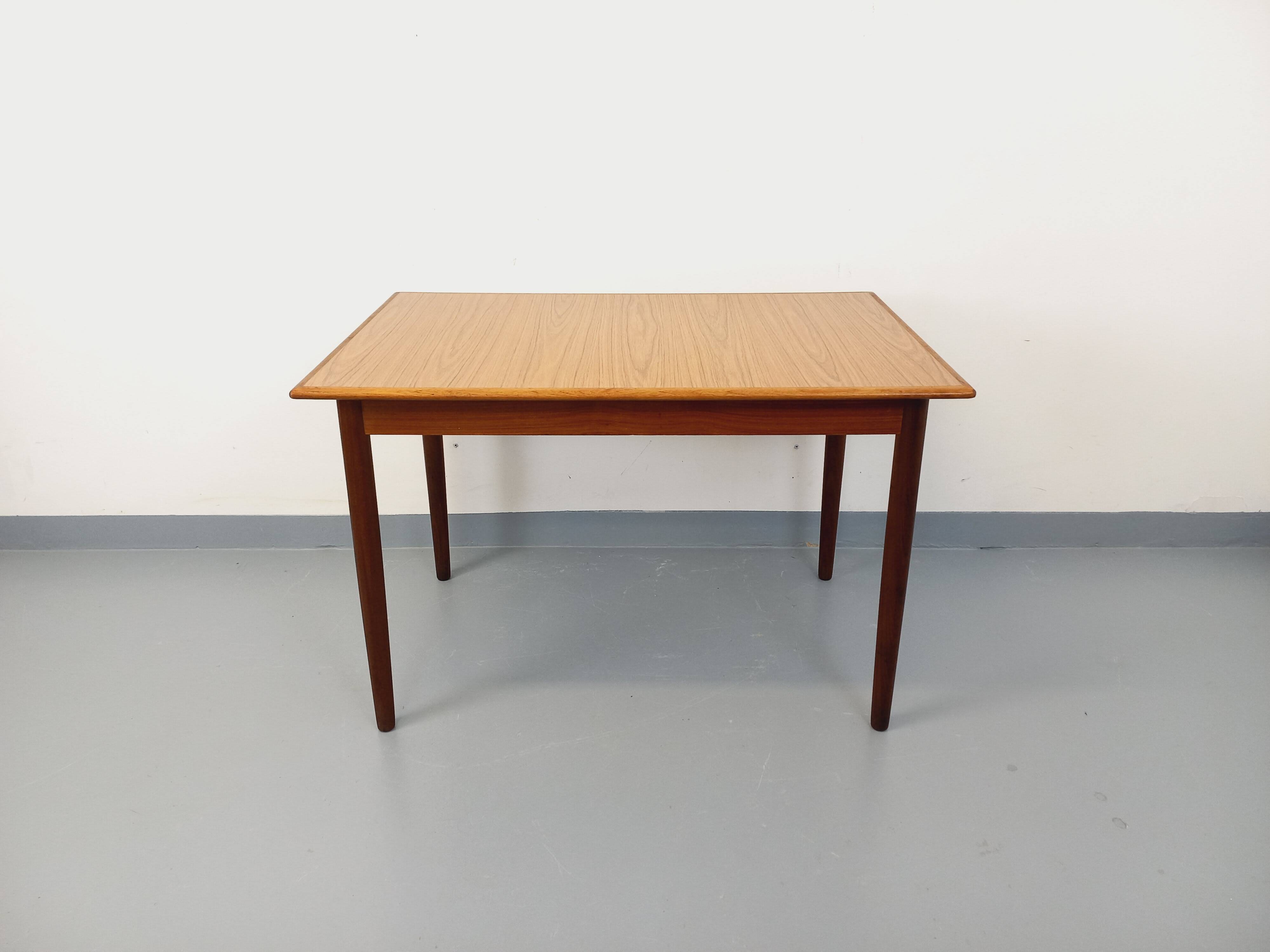 Rectangular dining table in vintage Scandinavian style made of teak and melamine.