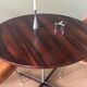 Round table in varnished rosewood