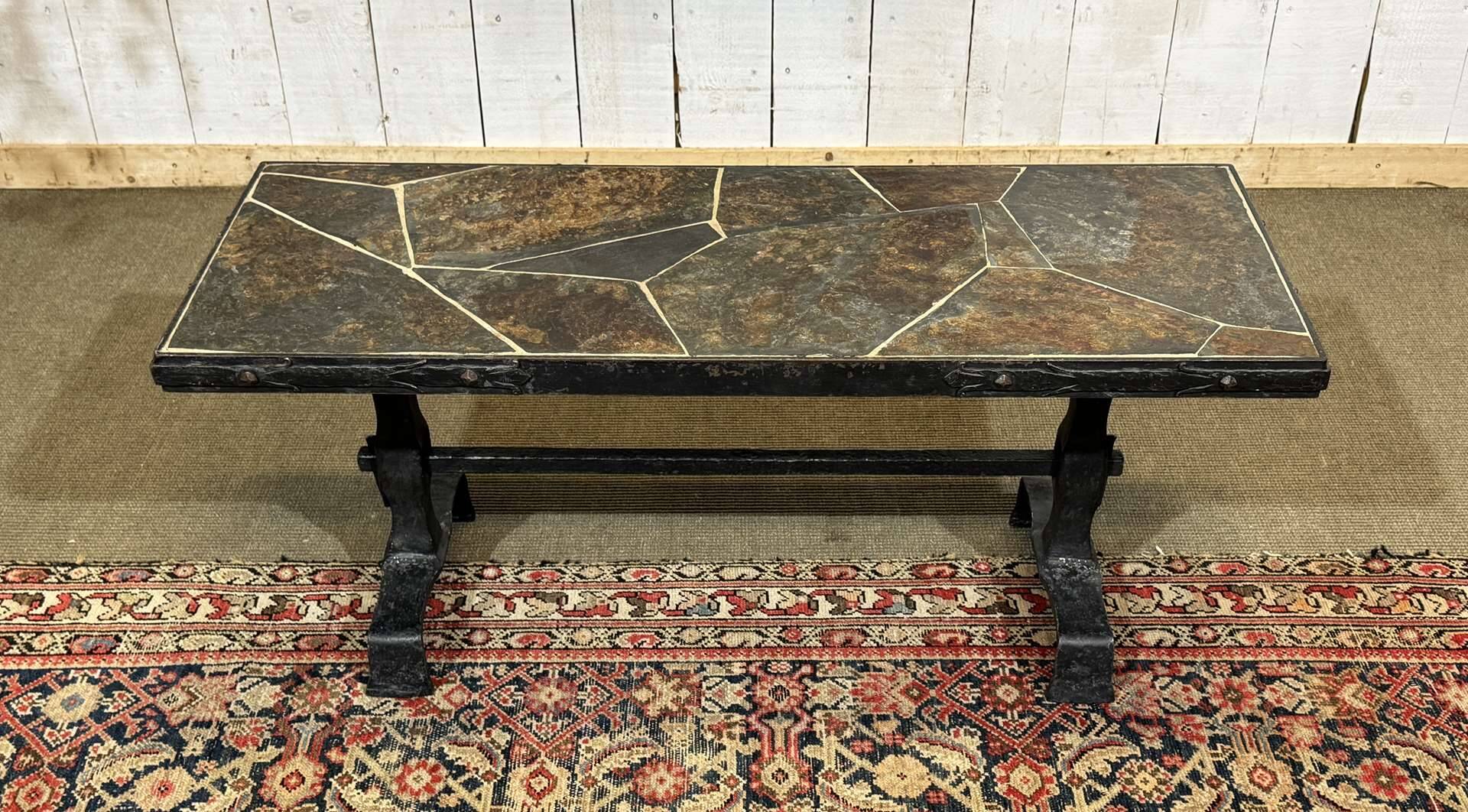 Coffee table in wrought iron with a slate top, work from the 1950s.