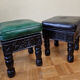 Pair of Moroccan poufs in stamped leather with a carved wooden base, Rabat