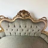 A soft light blue and silver tufted beech wood sofa in Louis style.