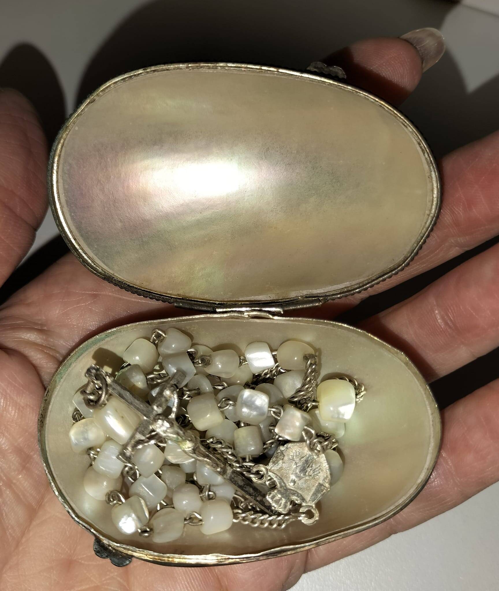 Old mother-of-pearl rosary in its egg box