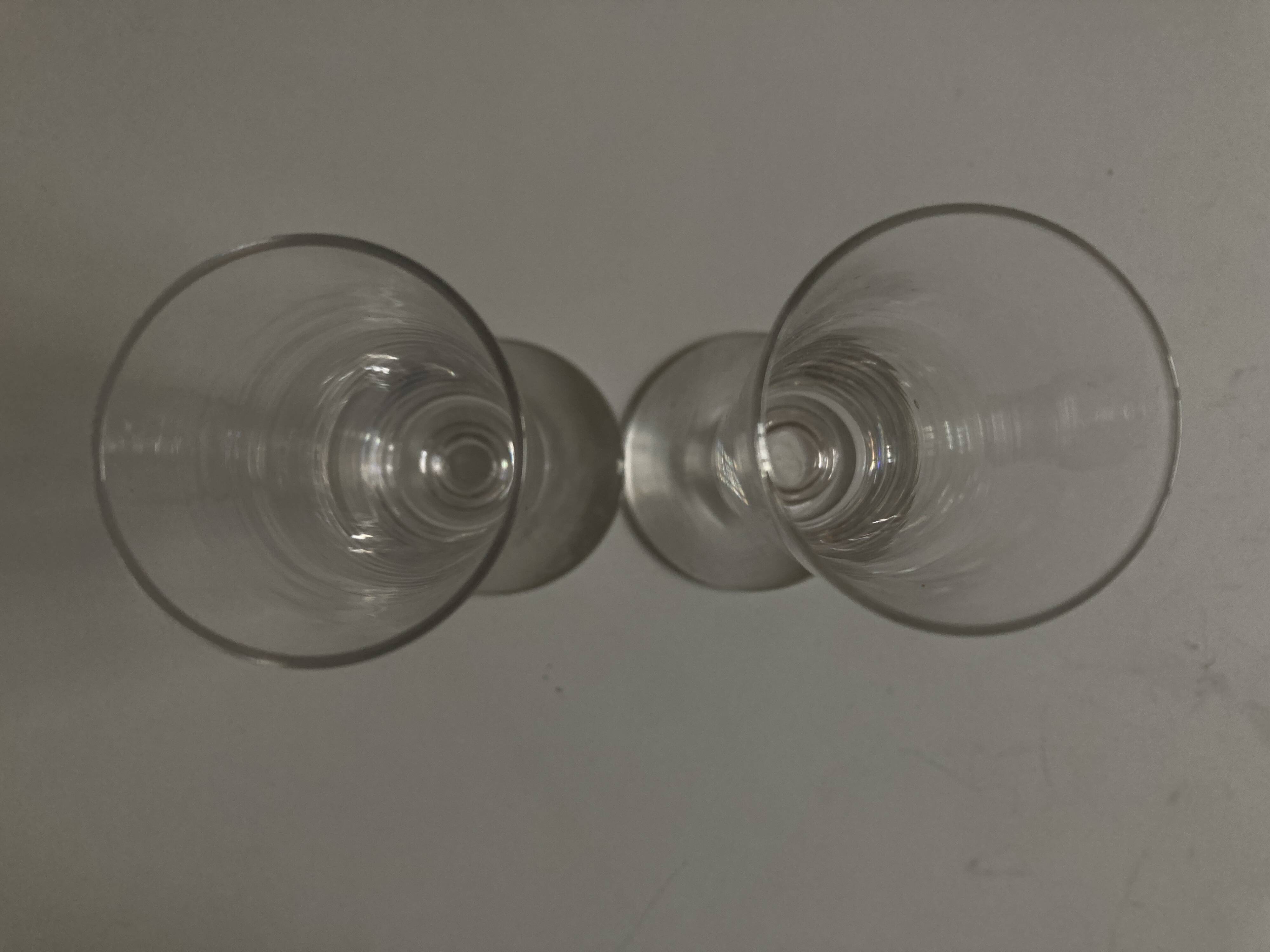 Pair of crystal champagne flutes with a button foot, 1960.