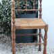 Antique corner chair in wood bamboo style seated in straw