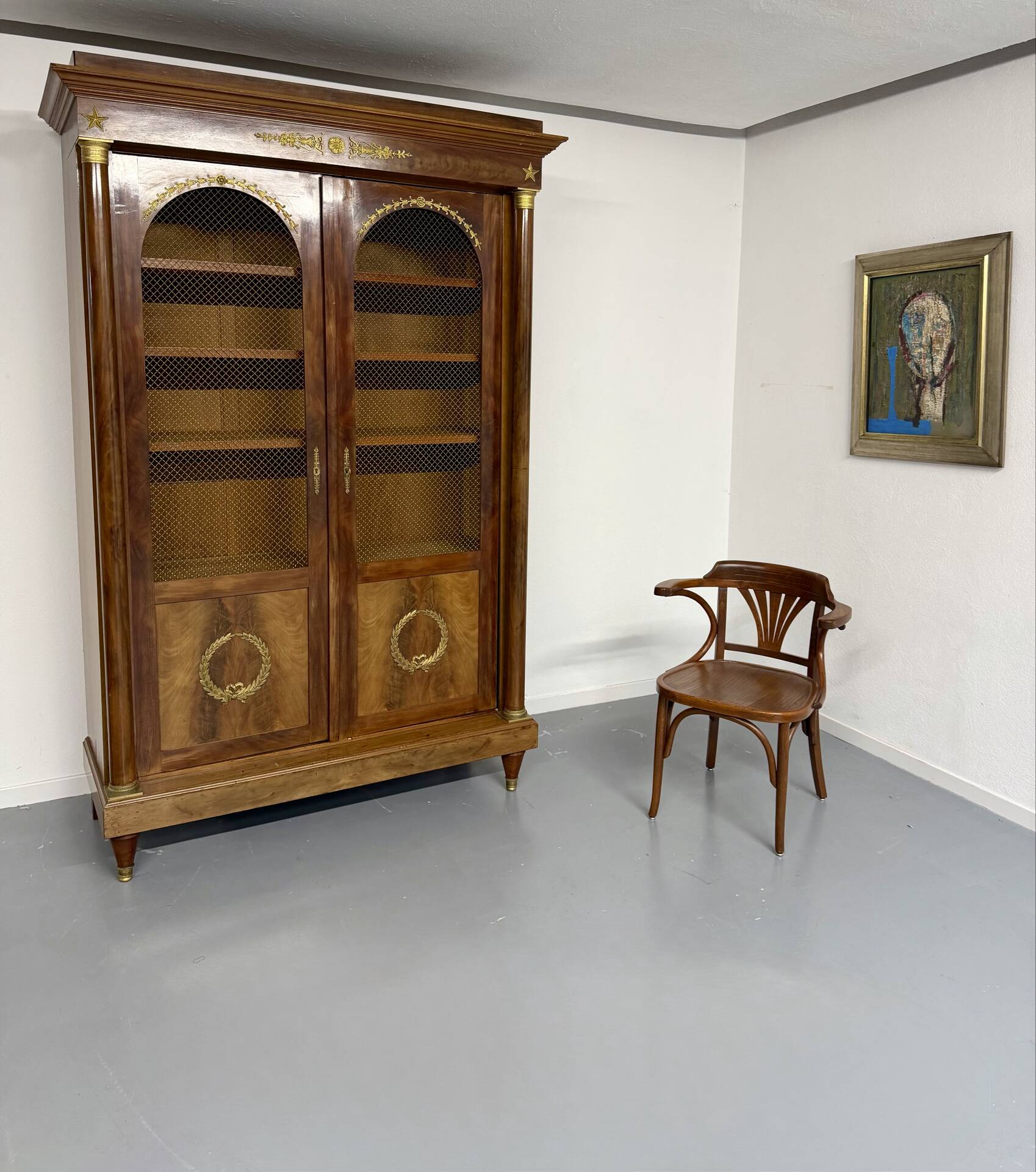 Large Empire-style library in wood with gilded bronze ornaments.