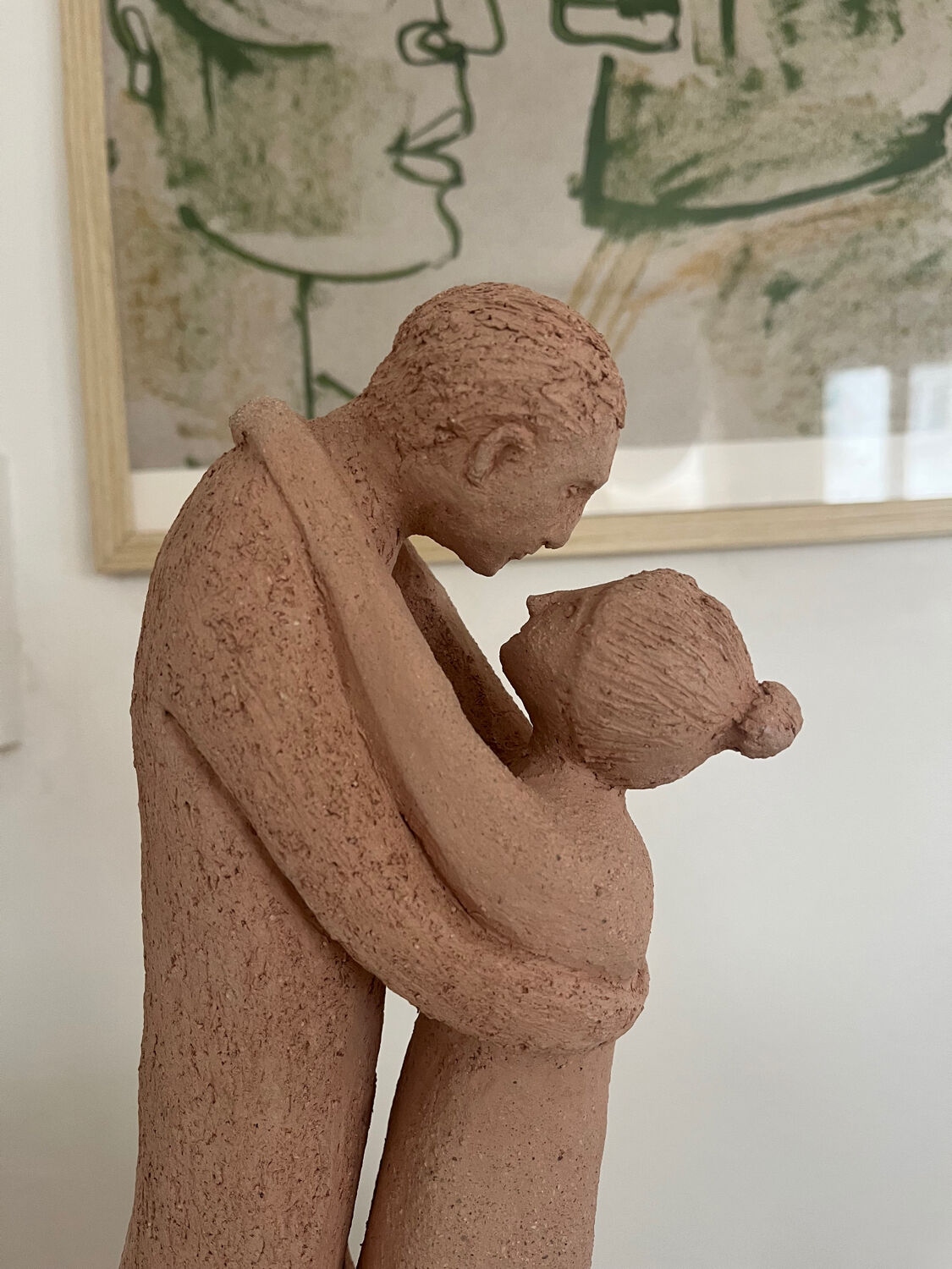 Terracotta sculpture of an entwined couple.
