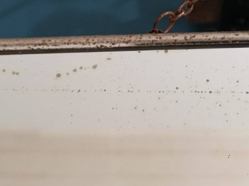 Barber mirror patinated metal surround