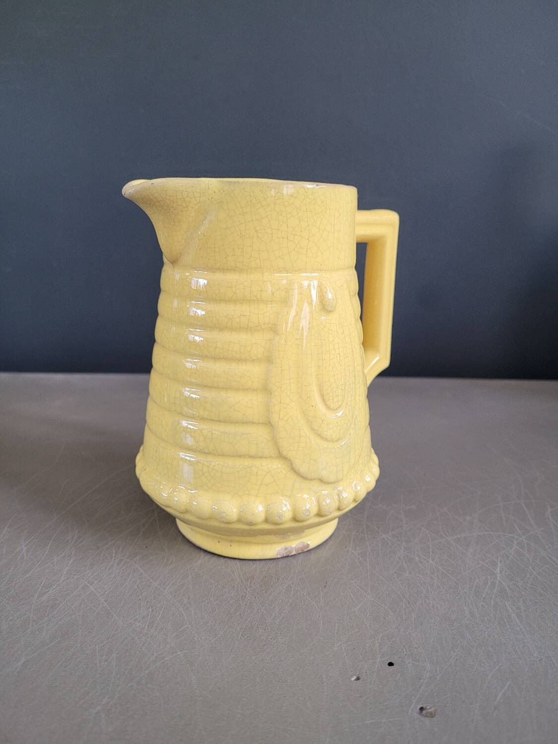 Yellow milk jug with reliefs