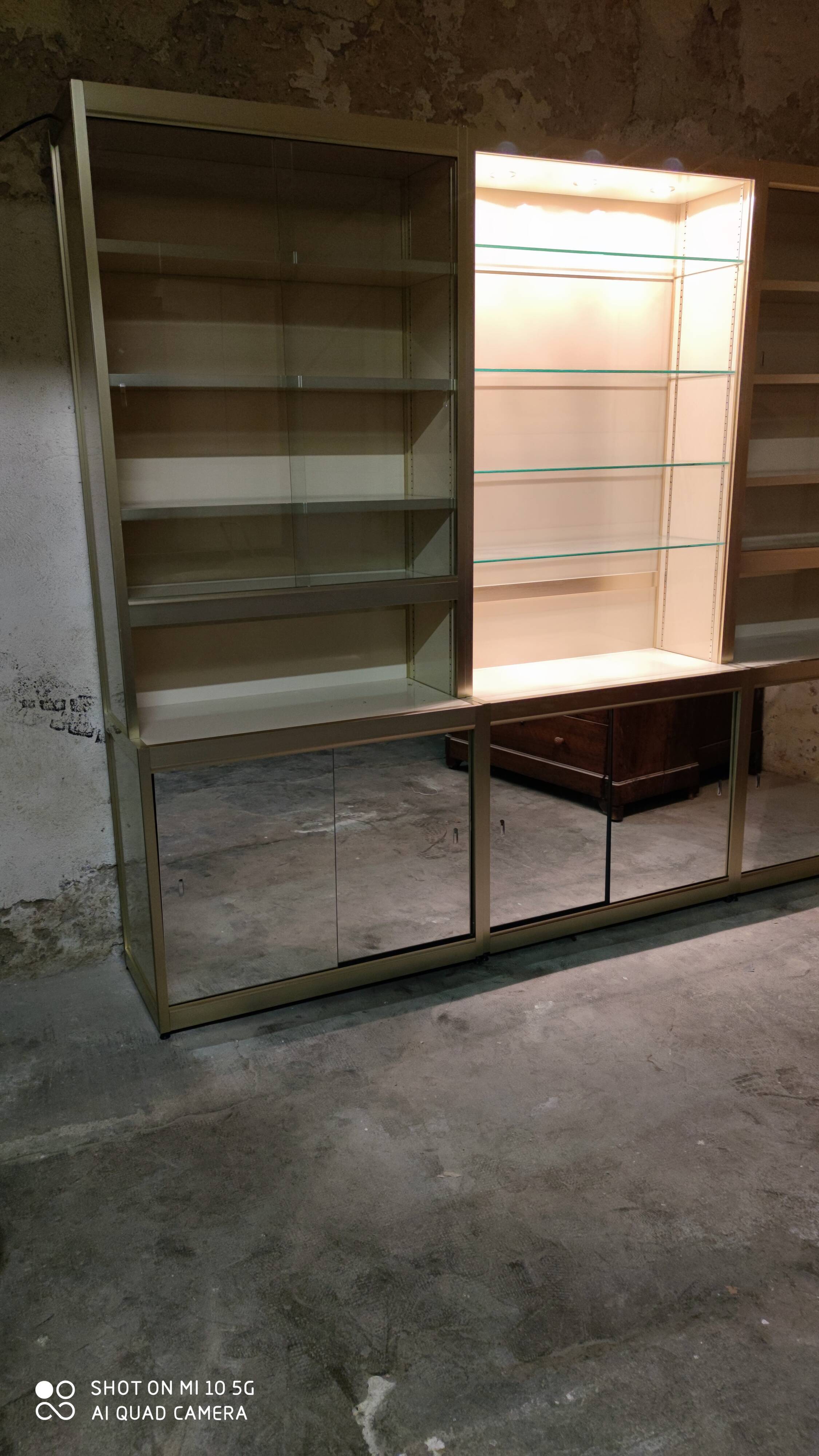 Ivory-colored and matte gold anodized aluminum display bookcase