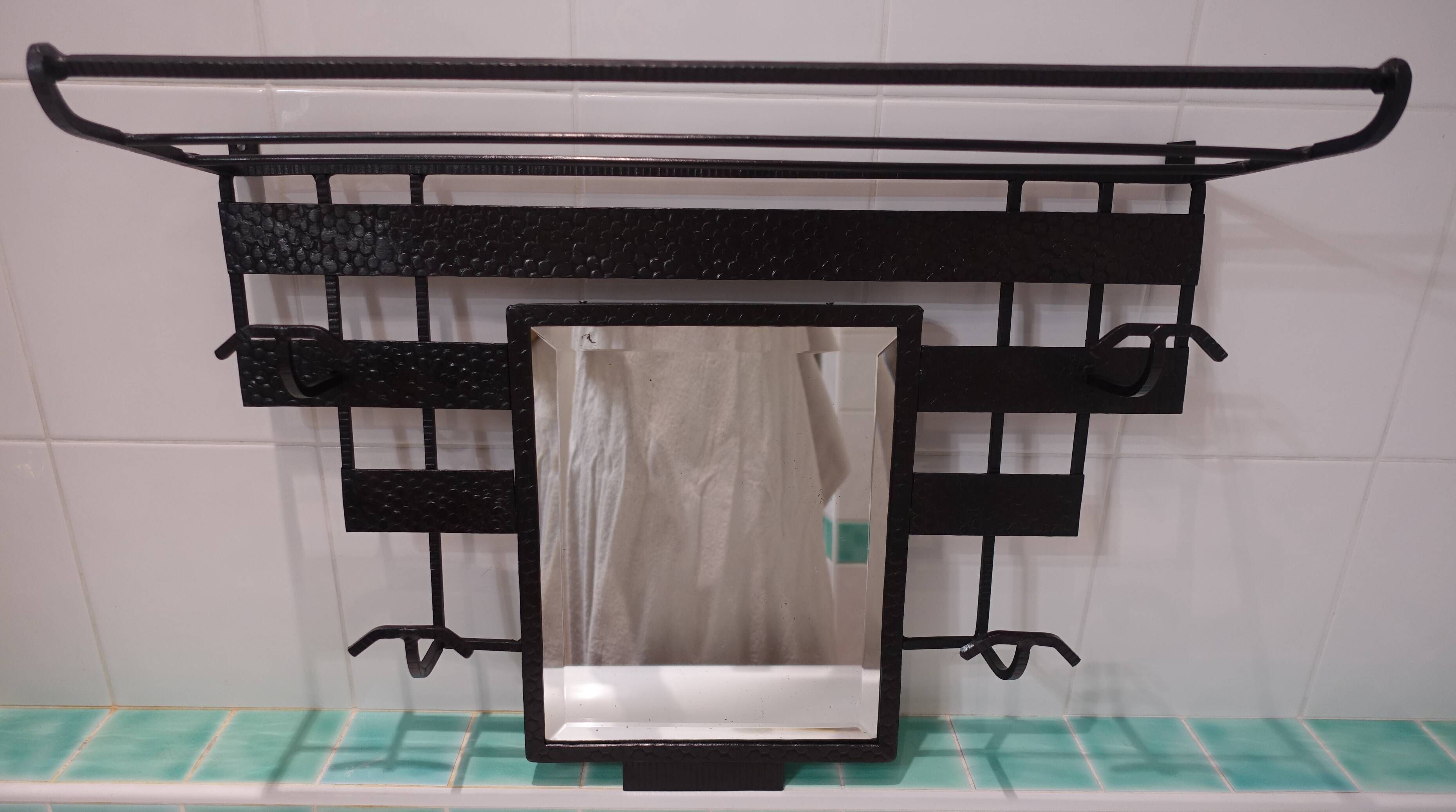 Art Deco wrought iron coat rack with bevelled mirror.