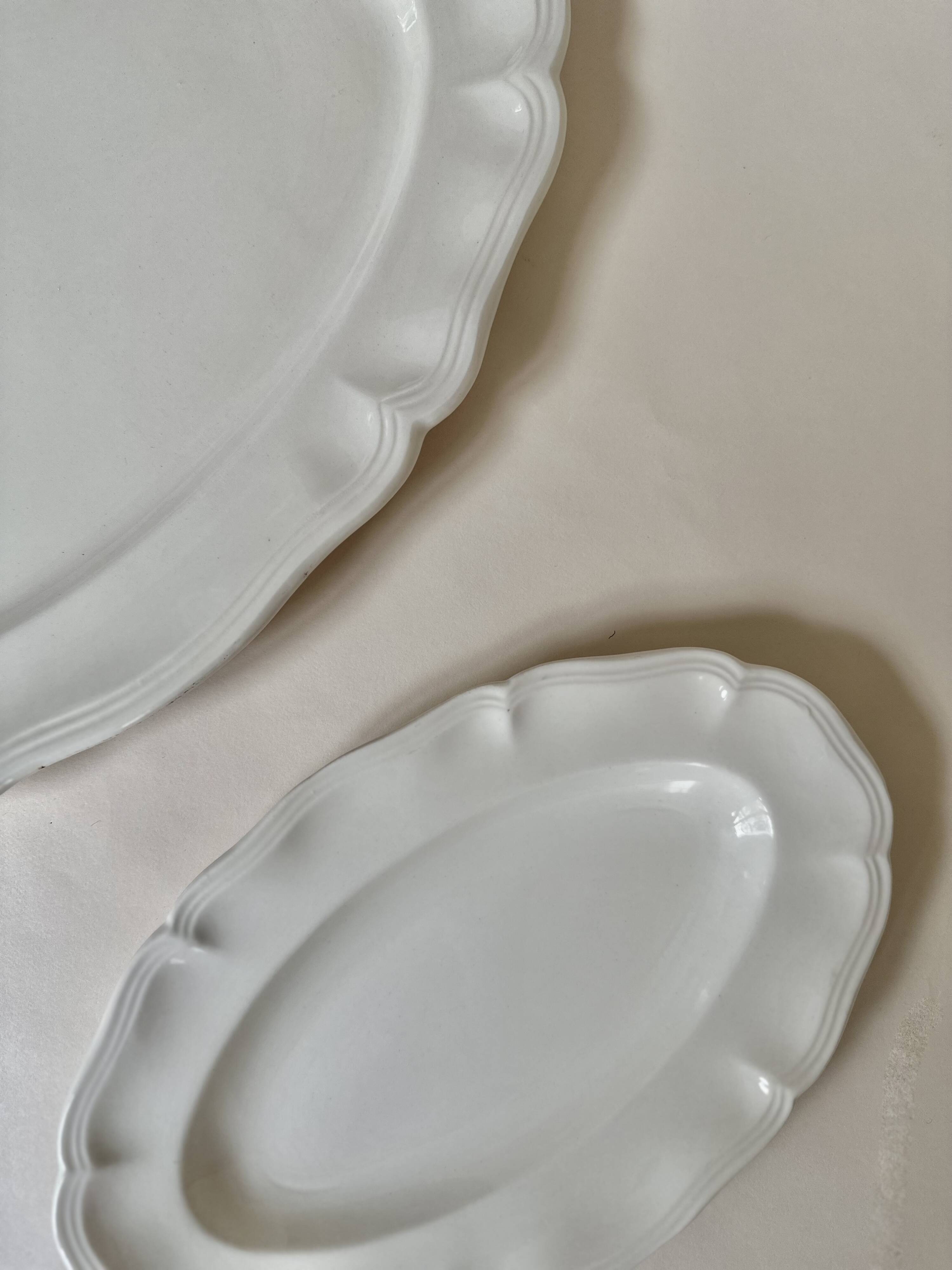 Shaped plates and dishes in Sarreguemines earthenware.