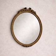 Antique oval mirror in Louis XVI style, gilded, with a bow pediment, 55cm.