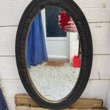 Old oval mirror with slate-coloured patina
