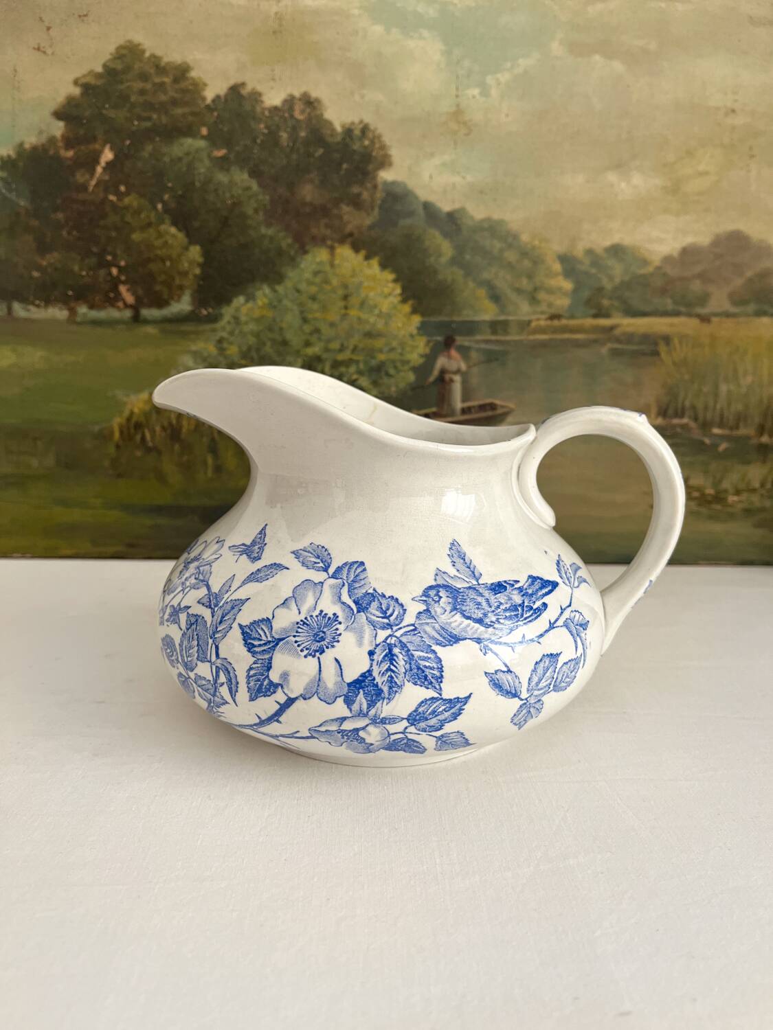 Antique chubby ironstone jug with floral and bird decoration