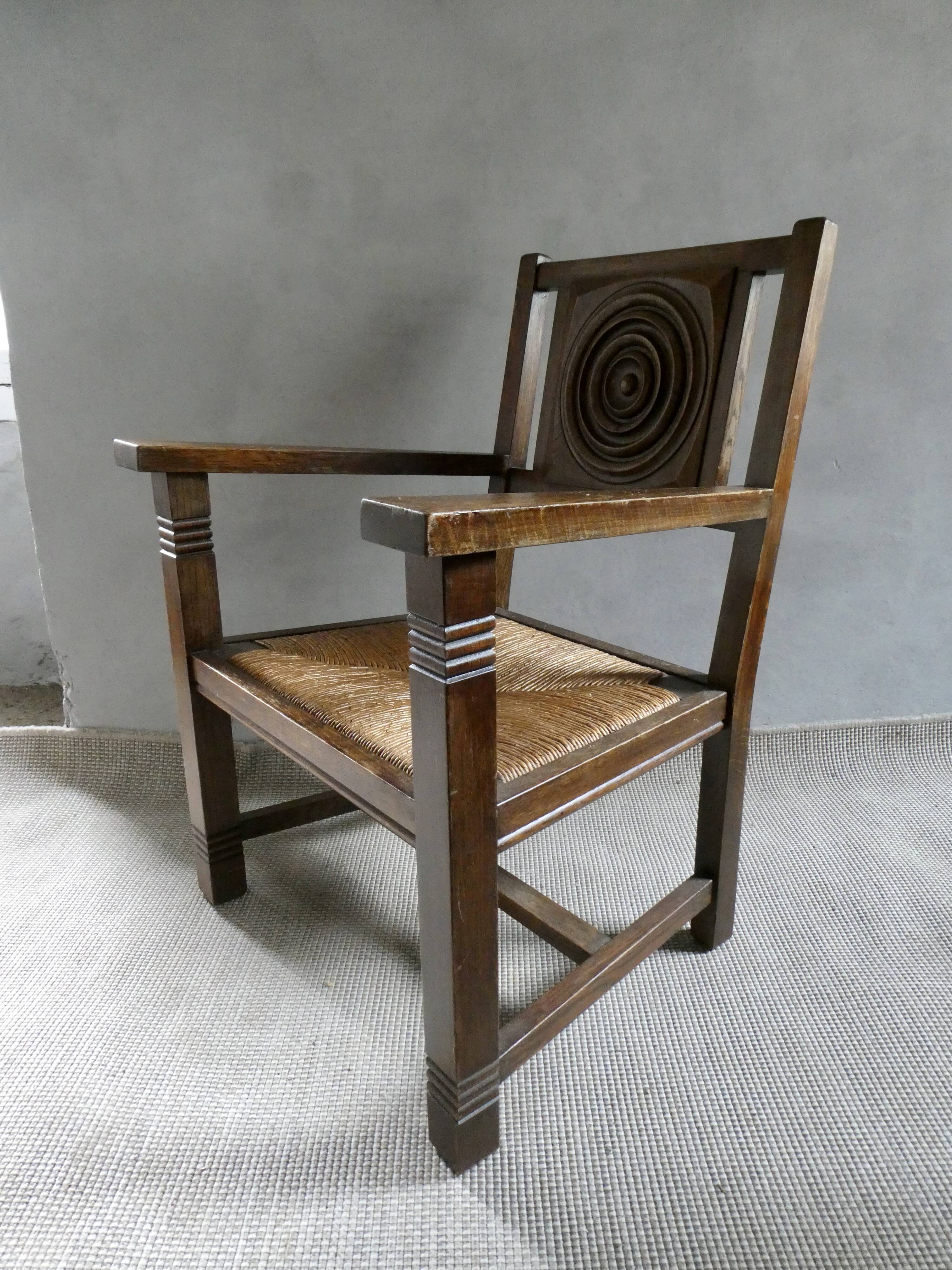 Armchair in carved solid wood with straw seat