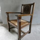 Armchair in carved solid wood with straw seat