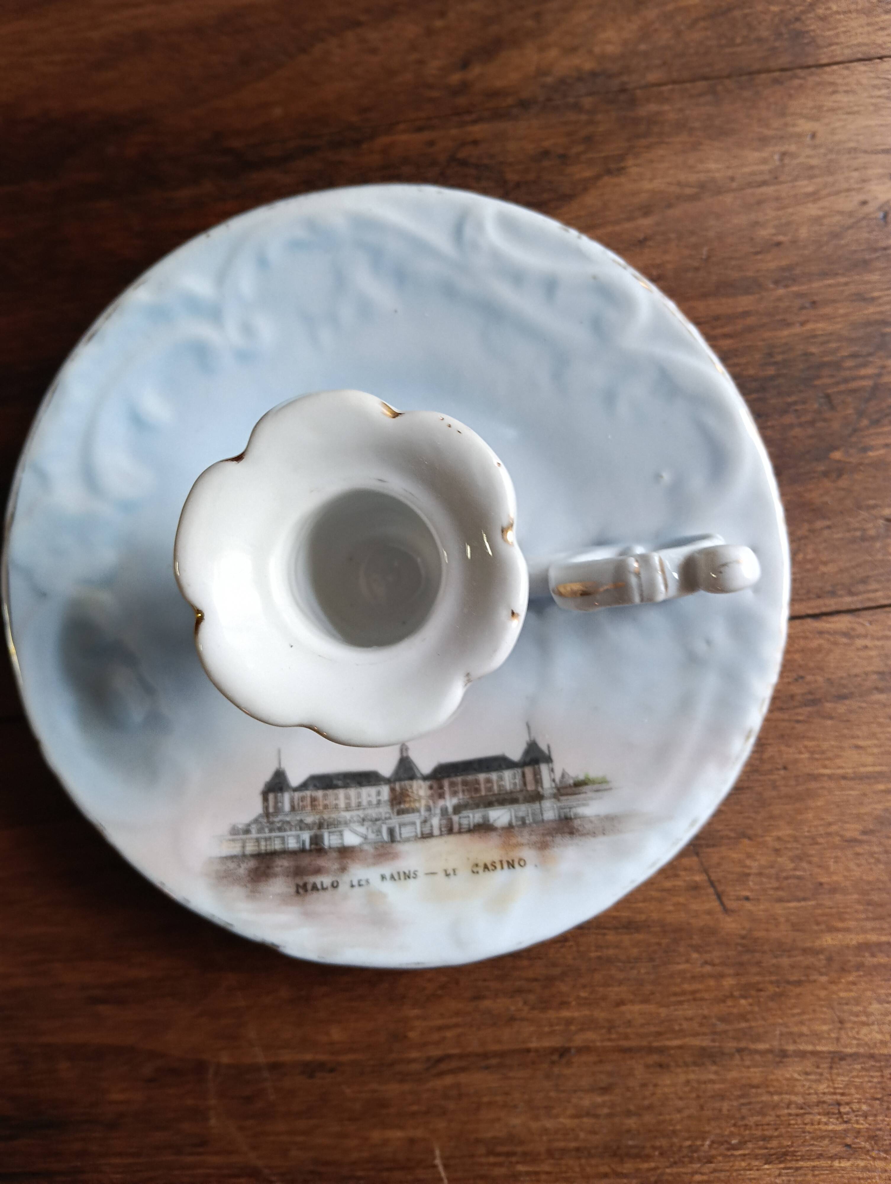 Antique handheld candle holder in porcelain