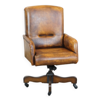 Swivel, height-adjustable, and tiltable sheepskin office chair on wheels