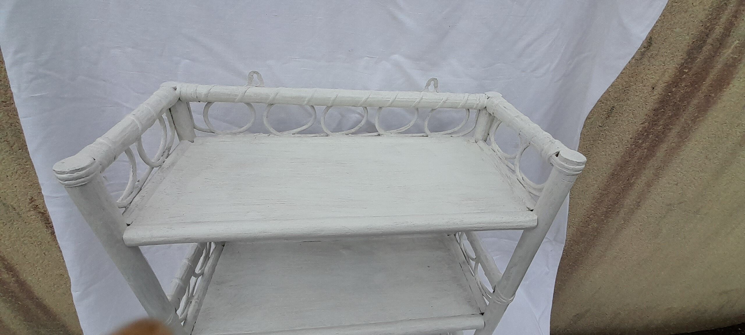 White rattan wall shelf