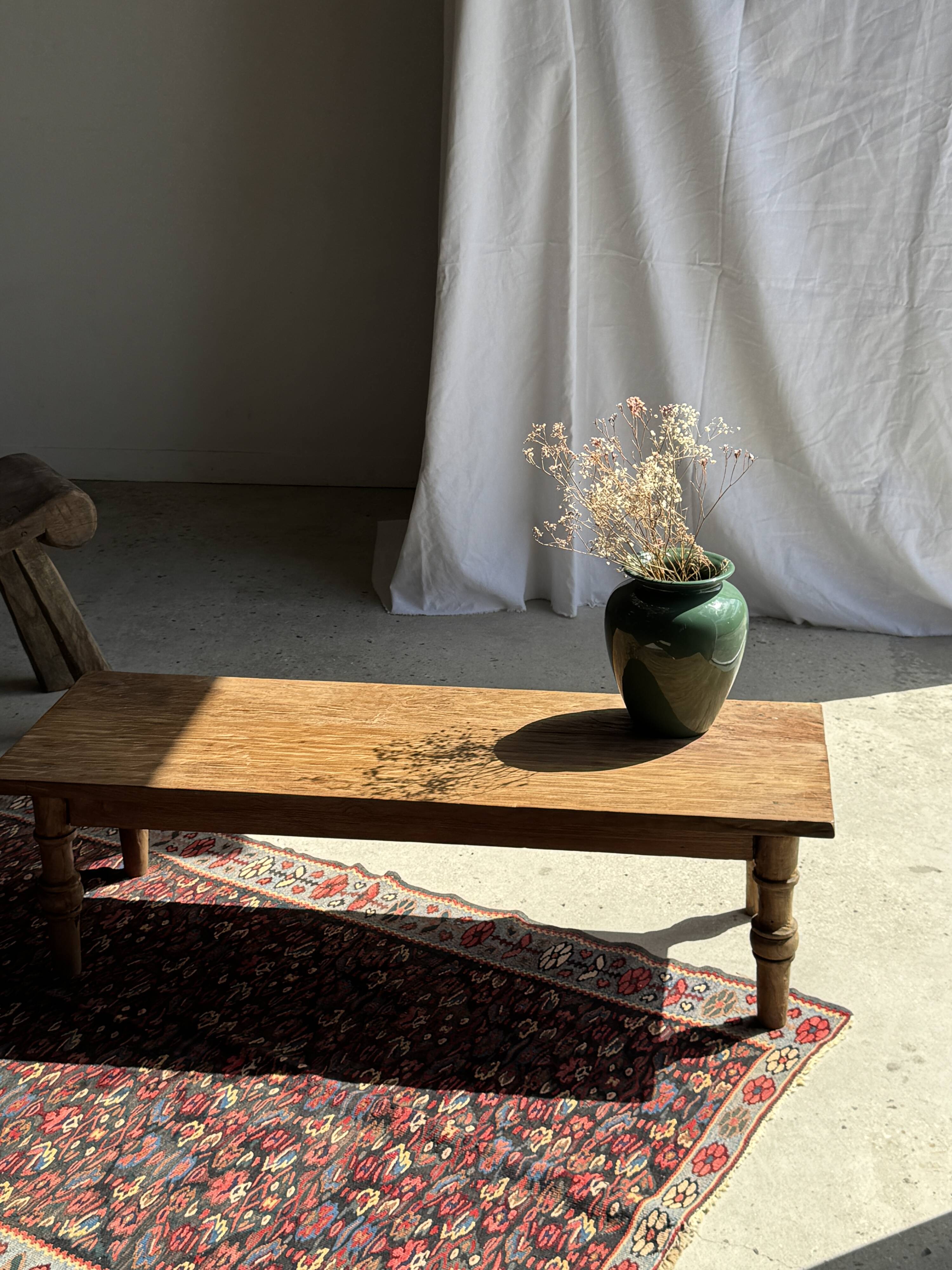 Brown Indonesian teak coffee table, with a border and cylindrical legs H40 L103.