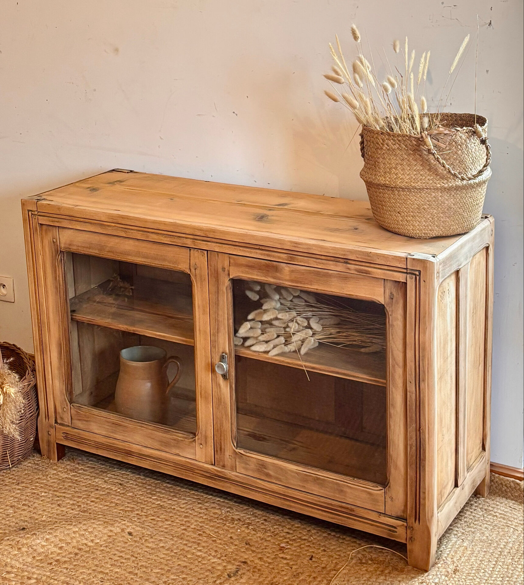 Old wooden buffet with a glass front in raw wood