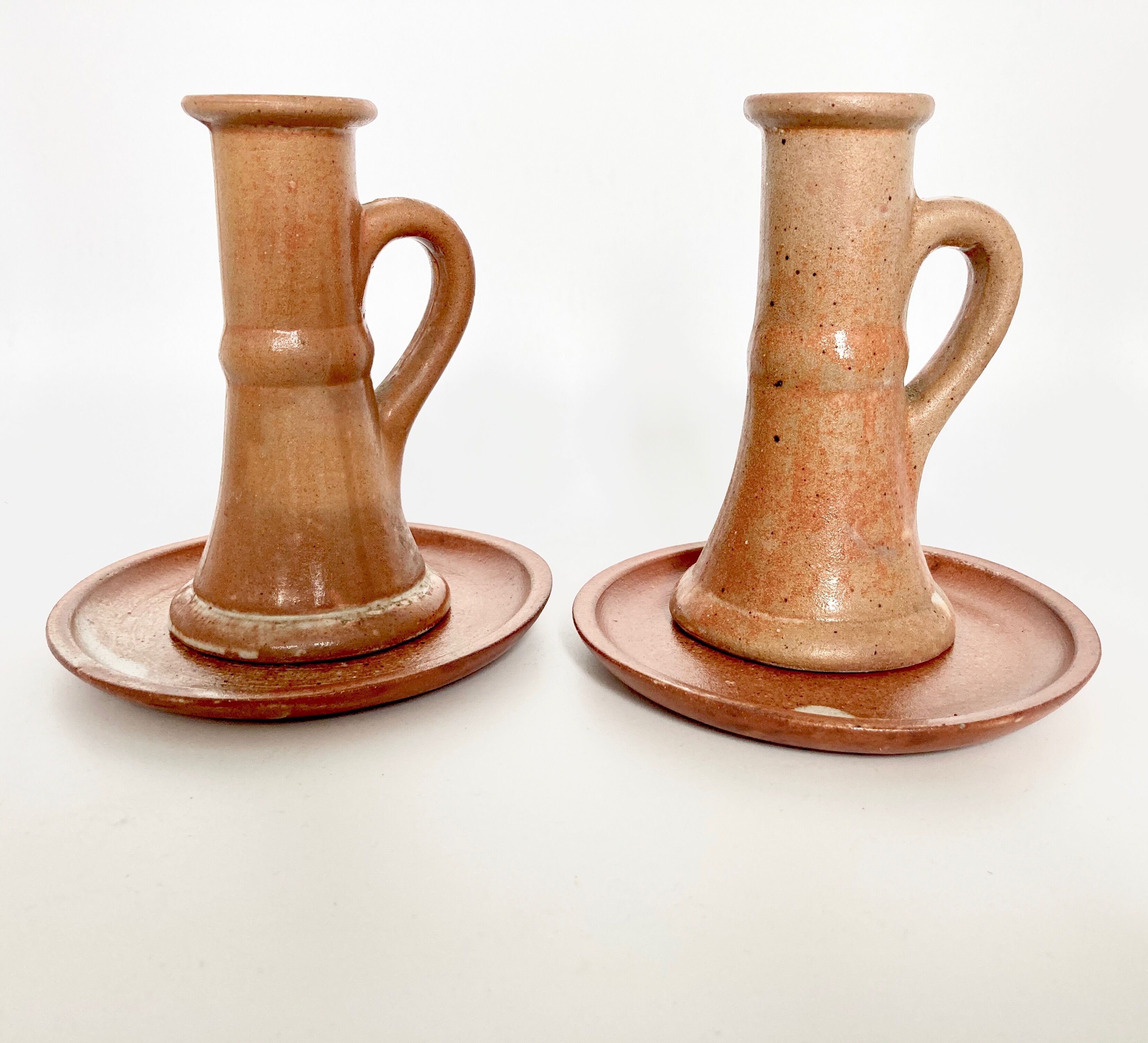 Pair of candlesticks and two sandstone cups