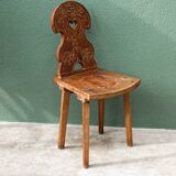 Old Swiss escabelle chair in carved wood