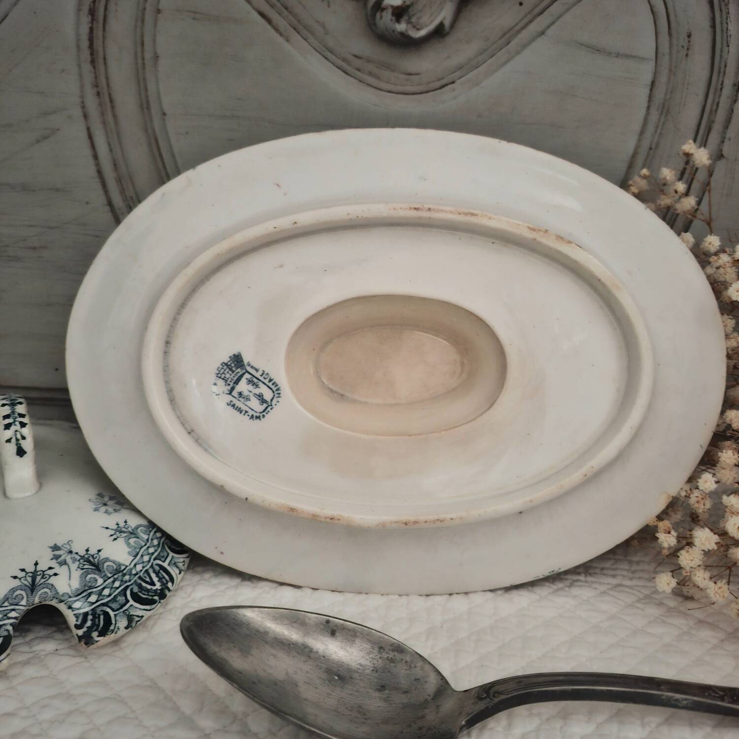 Antique iron earthenware sauceboat on a frame